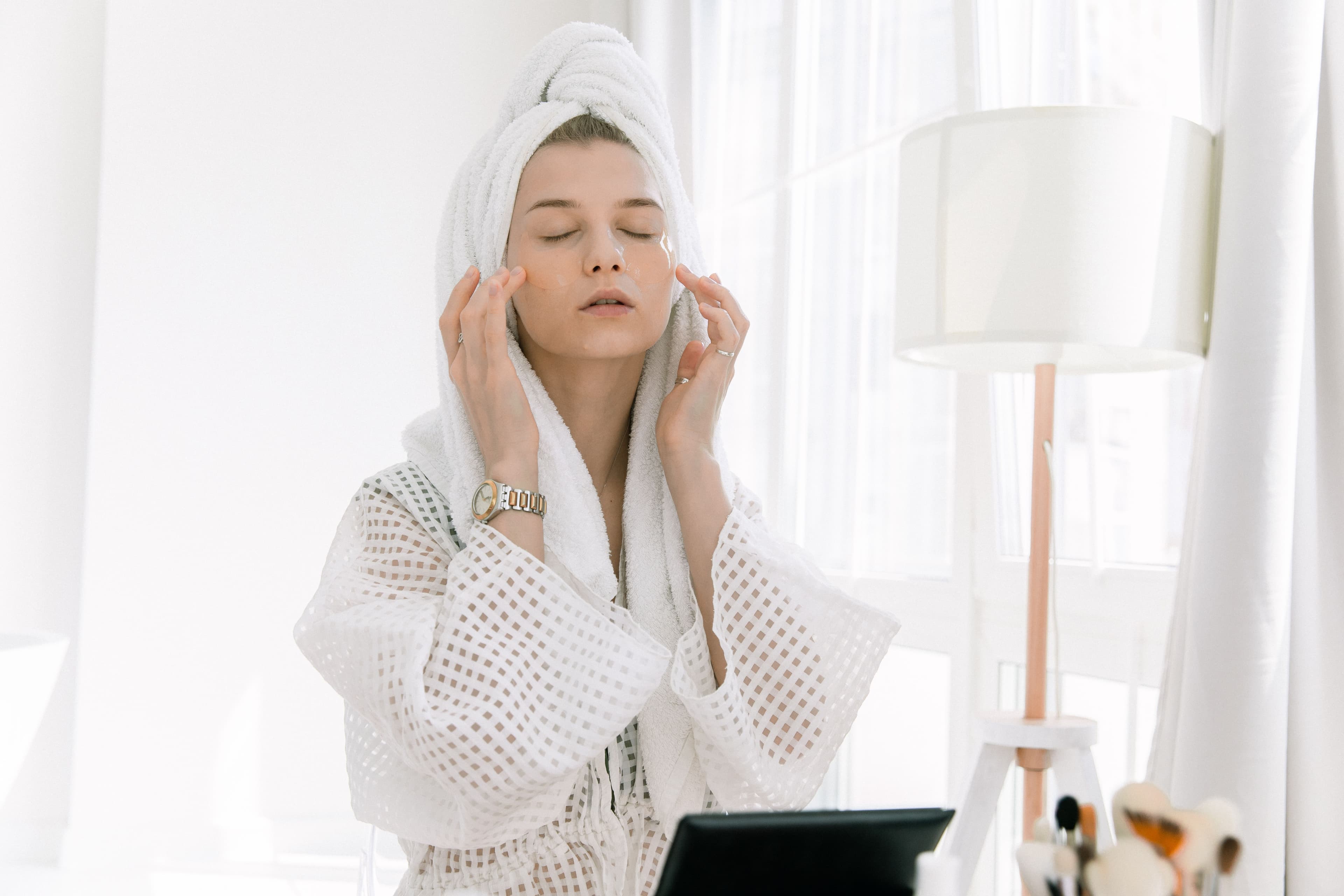 Simple skincare essentials — cleanser, moisturizer, and sunscreen — arranged on a light marble surface