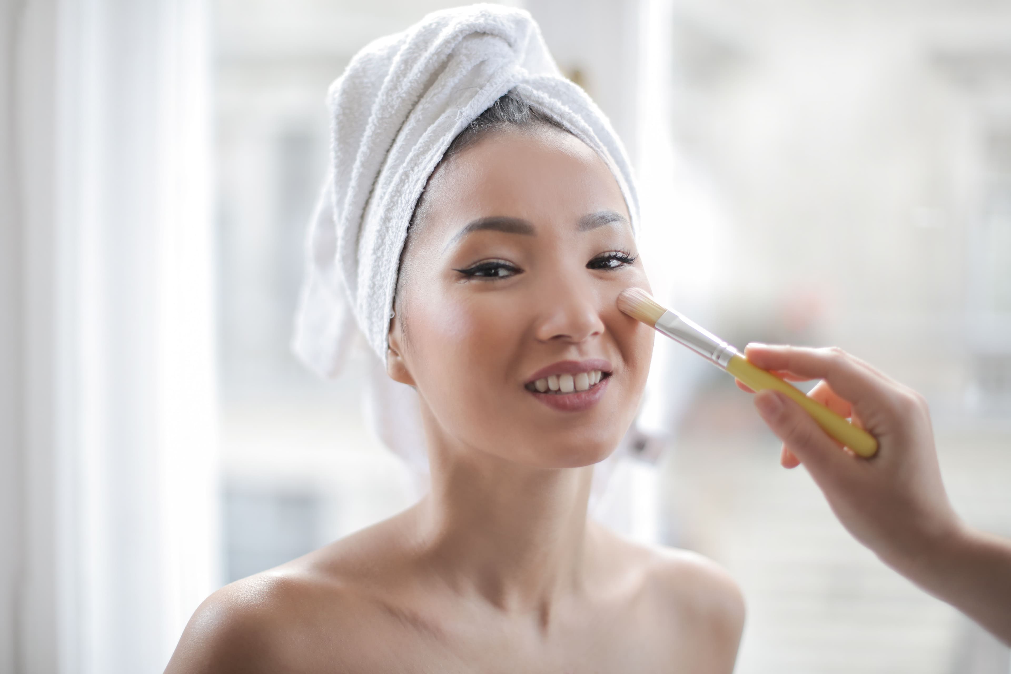 Oil-free monsoon skincare essentials with rain visible through a window in the background