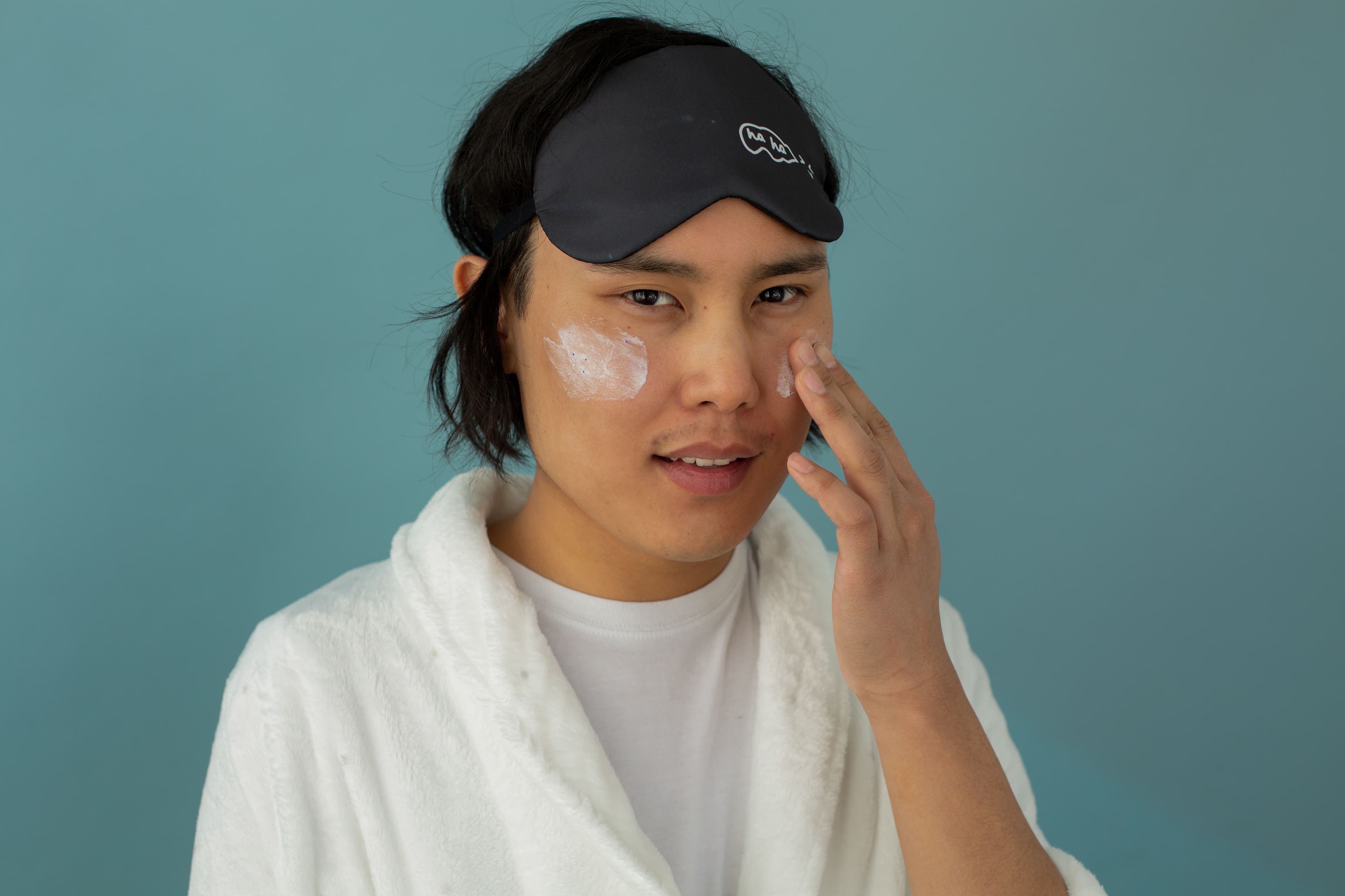 Simple teen boys skincare essentials including cleanser and sunscreen on a plain background