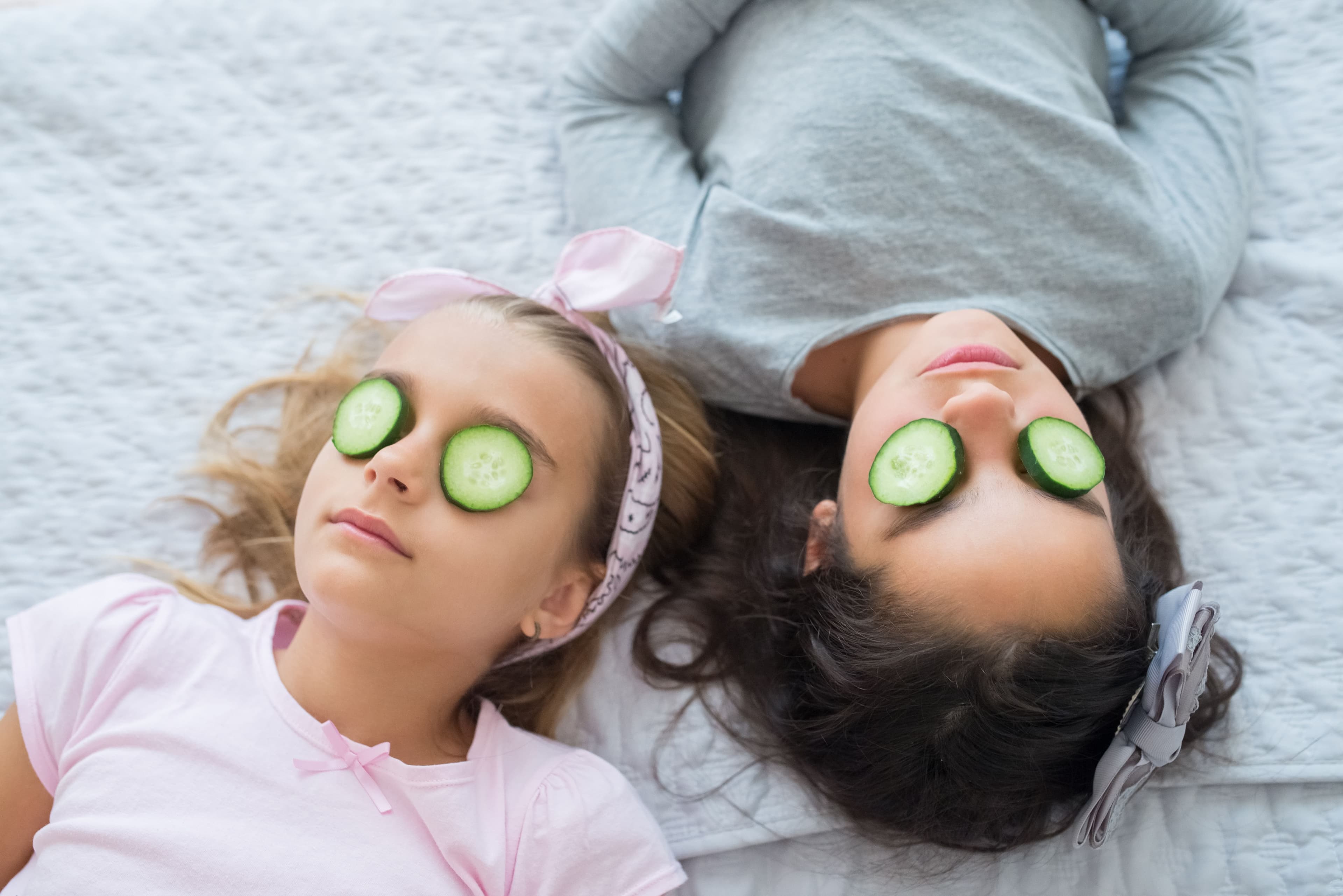 Simple, gentle teen girls skincare products including cleanser and sunscreen on a soft pastel background