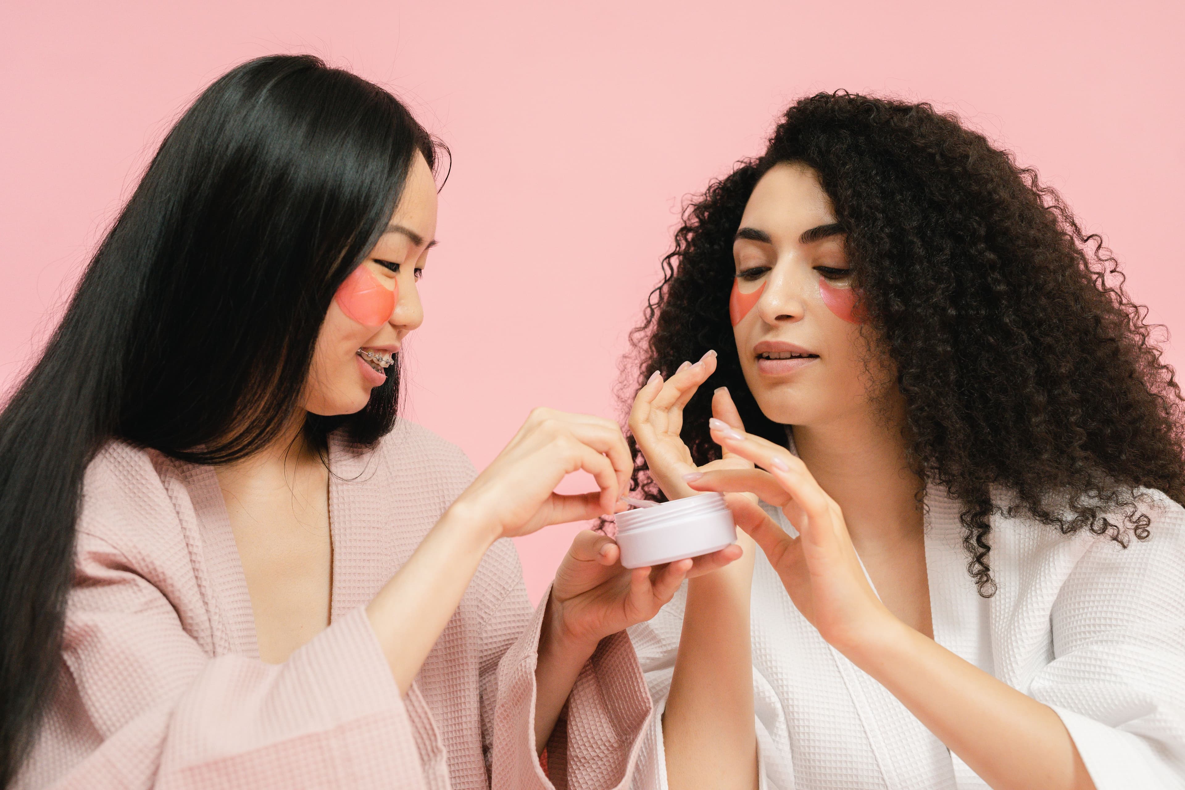 Bride's bridal skincare essentials laid out with a soft veil in the background