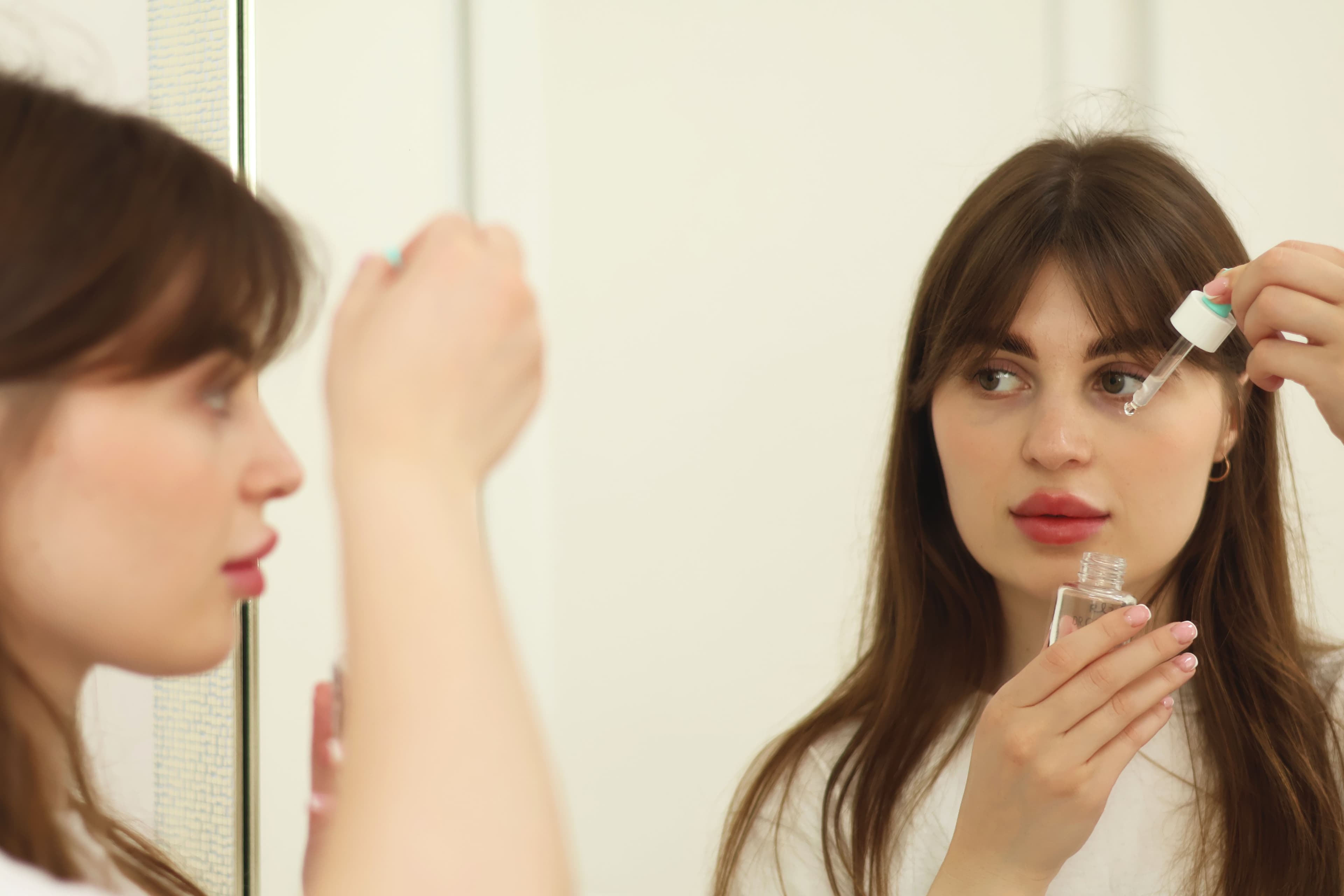 Four skincare product sets arranged by skin type — oily, dry, combination, and sensitive — on a neutral background